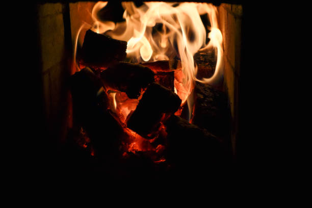 fire burns in the fireplace. Fireplace with flame fire ashes.