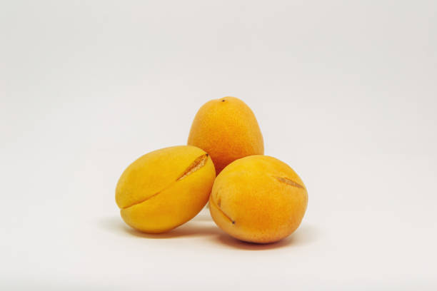 Three oranges are piled on top of each other. The oranges are ripe and ready to eat. Concept of abundance and freshness