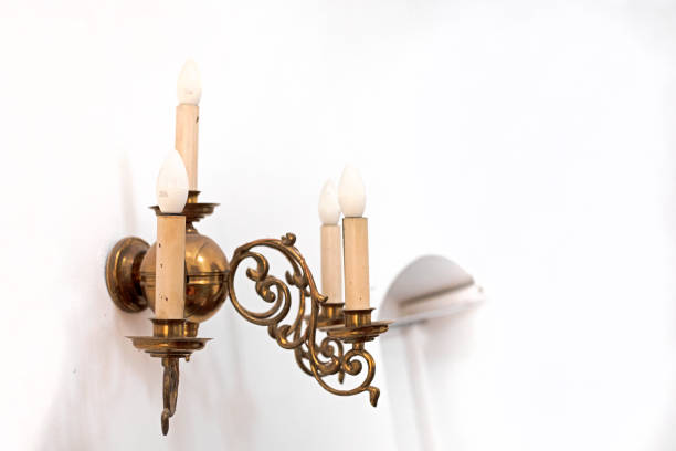 candle-shaped wall lamp in a bright interior
