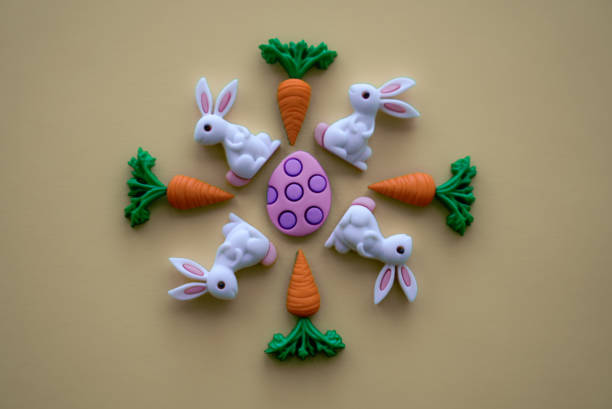 Cute easter bunny outdoors in meadow, surrounded byy thyme in bloom at springtime