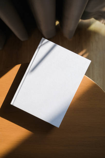 istock blank book mockup on wooden coffee table , shadow overlay 2206388679