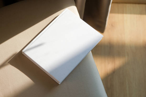 istock blank book mockup on soft armchair , shadow overlay 2206388731
