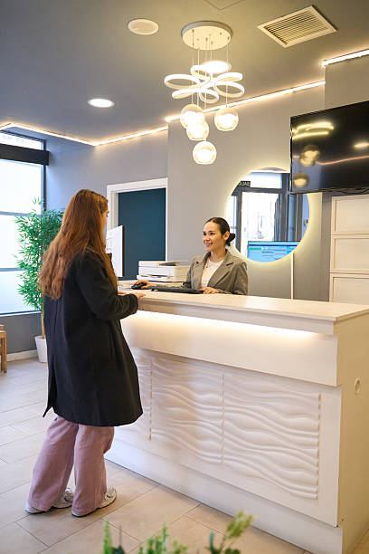 istock Patient interacting with receptionist at dentist's office 2206393349