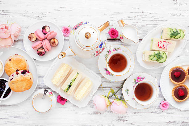 istock Afternoon tea table scene against a white wood background 2206395221