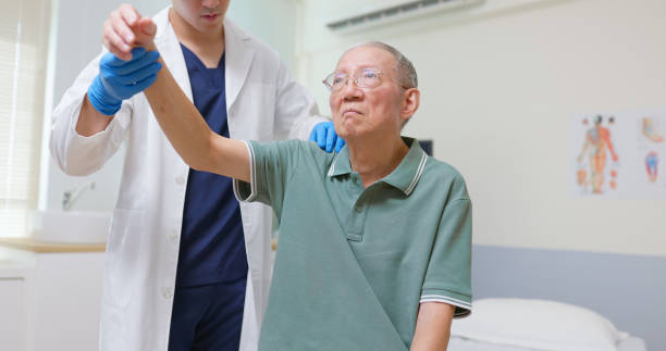 istock Asian Therapist Aids Arm Recovery 2206401682