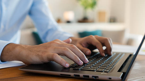 istock Businessman working remotely from home office typing on laptop keyboard 2206402731