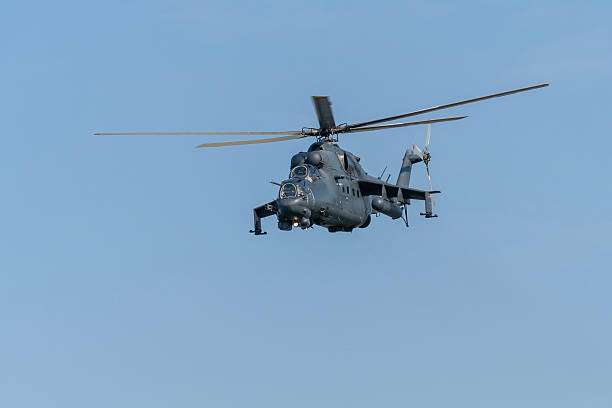 istock Soviet-made black Mi-24 military helicopter flying in the sky 2206403188