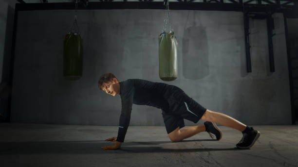 istock Sportsman doing push-ups in a boxing gym 2206404170