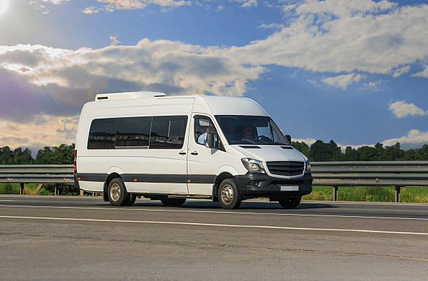 istock Minibus moves along a country road 2206404799