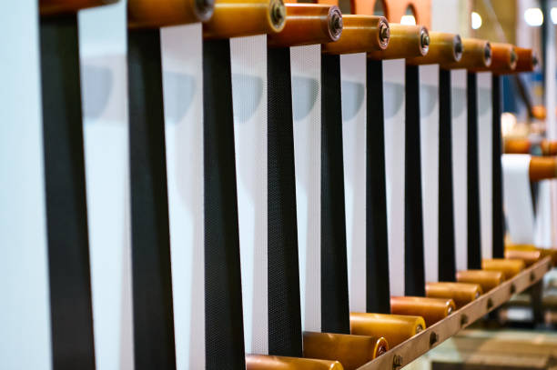 Wide view of a jacquard loom with colored heddles guiding warp threads for precision weaving in a modern textile factory