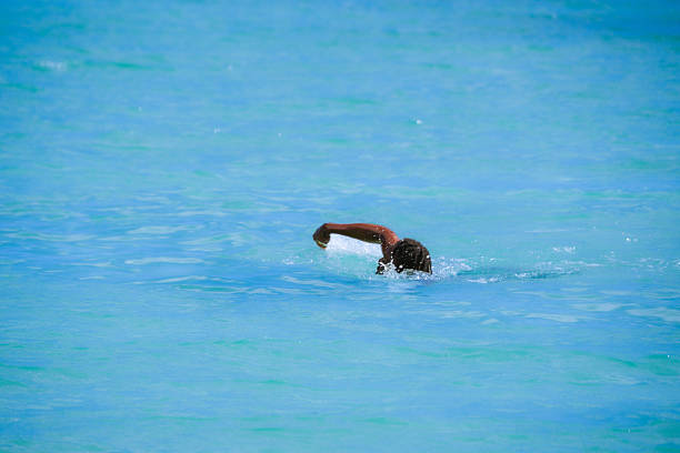Man swimming on Bavaro Beach in Punta Cana, Dominican Republic