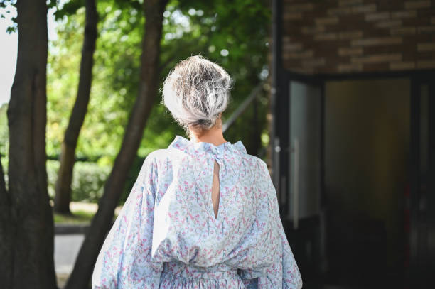 istock Senior woman walking away in a park setting 2206408491