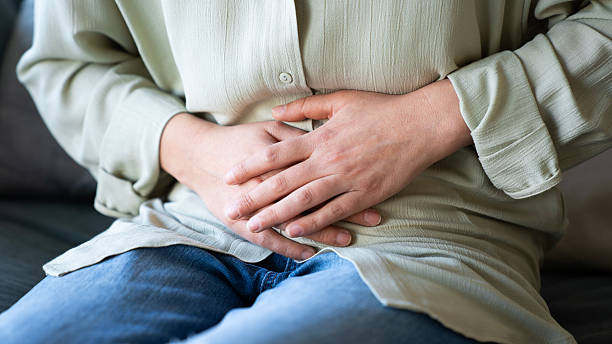 istock Young woman with stomach ache 2206408802