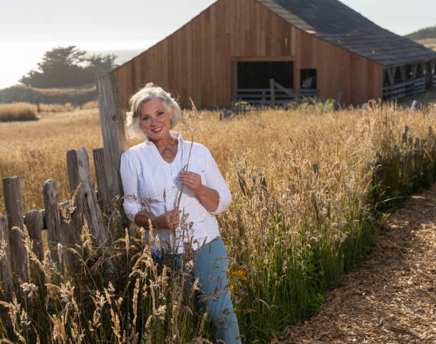 istock Middle age woman posing outdoors by barn. Professional model. 2206409861