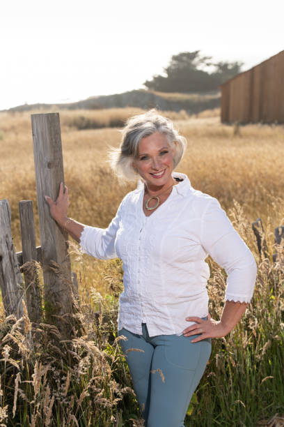 istock Middle age woman posing outdoors by barn. Professional model. 2206409919