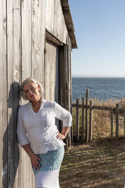 istock Middle age woman posing outdoors by barn. Professional model. 2206409933