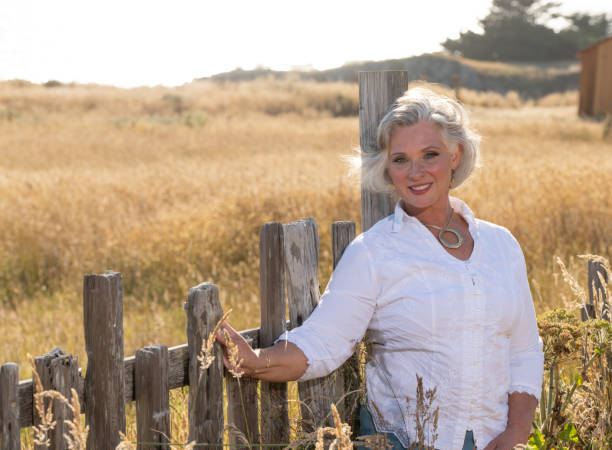 istock Middle age woman posing outdoors by barn. Professional model. 2206409943