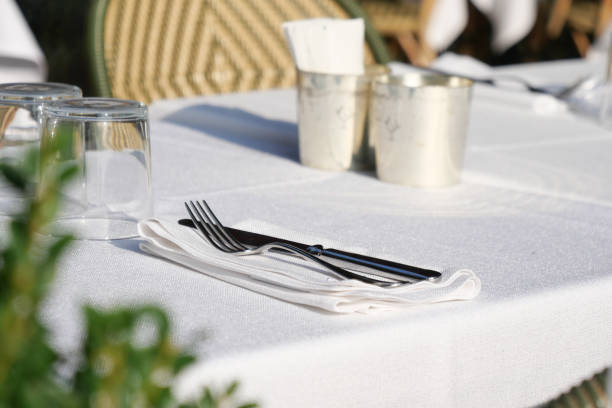 istock An Elegant Table Setting Complete with Silver Cutlery and White Linen Fabrics 2206410936