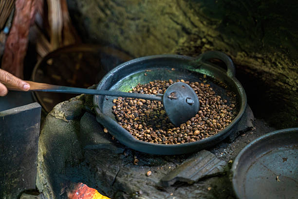 istock Hand stirring roasting coffee beans in a dark 2206411695