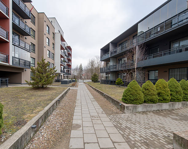 istock Modern Apartment Building Exterior with Green Lawn and Walking Path 2206411987