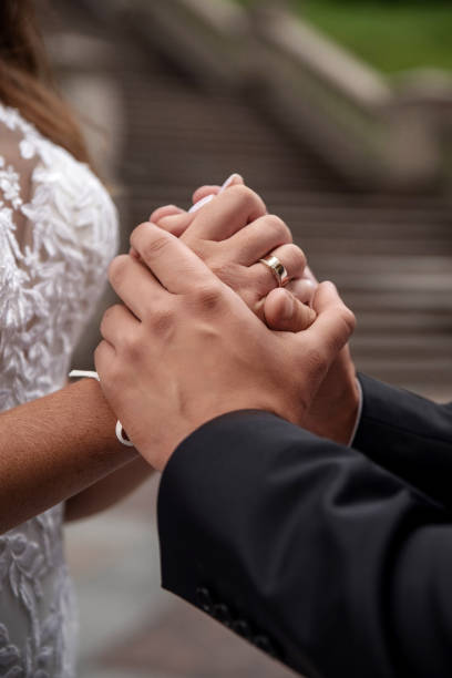 istock Groom holding bride's hands, close-up 2206415651