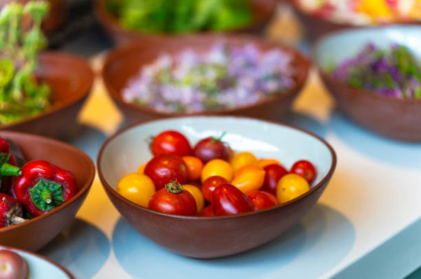 Colorful cherry tomatoes, red peppers and other condiments