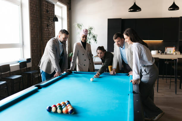 istock Business team playing billiards during break time in modern office 2206418675