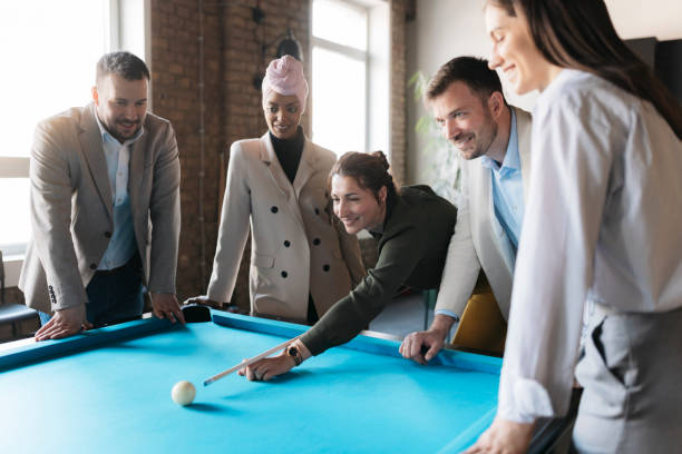 istock Business team playing billiards during break time in the office 2206418733