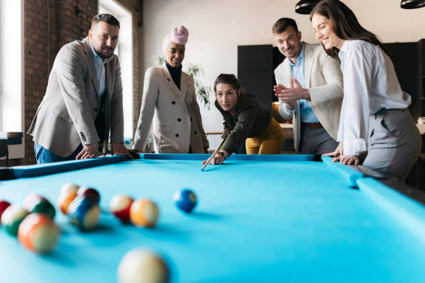 istock Business team playing billiards during break time in office 2206418737
