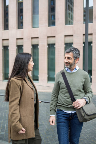 istock Business people walking and talking outside office building 2206419242