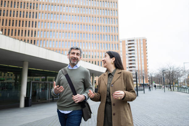 istock Business people walking and talking outside office building 2206419458
