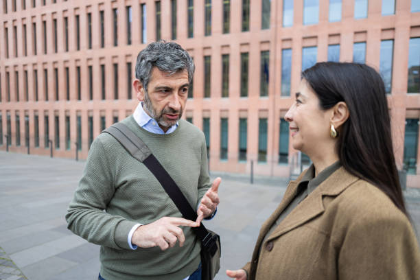 istock Businesspeople discussing a project outside office building 2206419499
