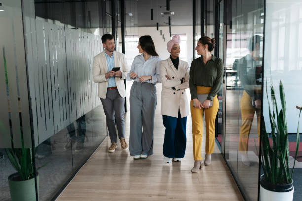 istock Business people walking and talking in modern office corridor 2206419516