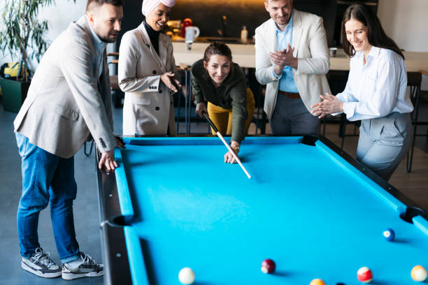 istock Business colleagues playing pool during a break in the office 2206420232