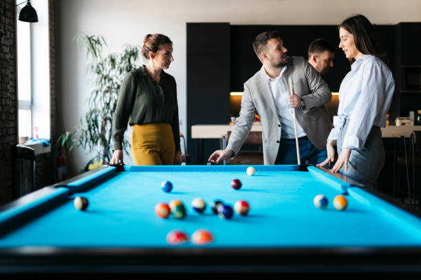 istock Business colleagues playing pool during a break in the office 2206420522