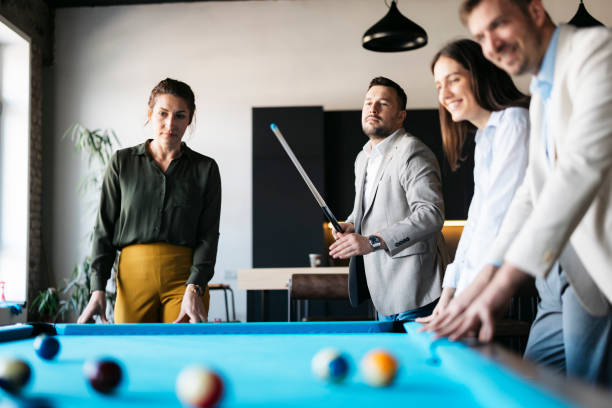 istock Business people playing pool in the office during a break 2206420584