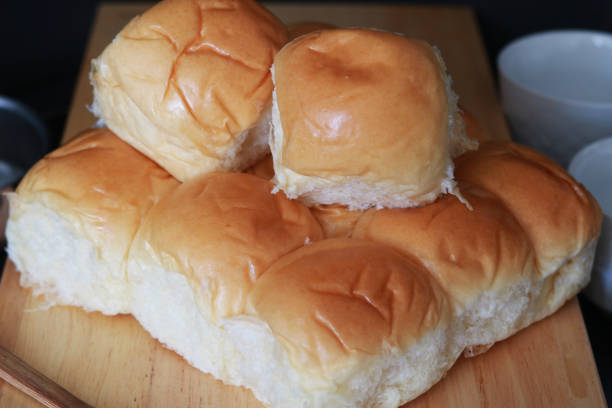 istock Freshly Baked Soft Bread Roll Held in Hand – Warm, Fluffy, and Golden-Brown 2206424737