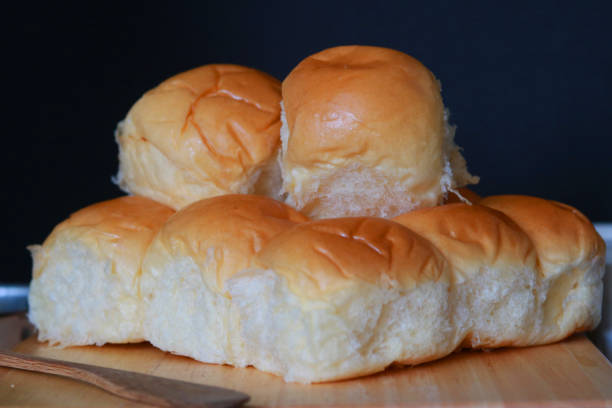 istock Freshly Baked Soft Bread Roll Held in Hand – Warm, Fluffy, and Golden-Brown 2206424738