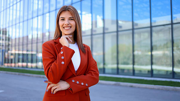 istock Smiling businesswoman posing outside modern office building 2206426040