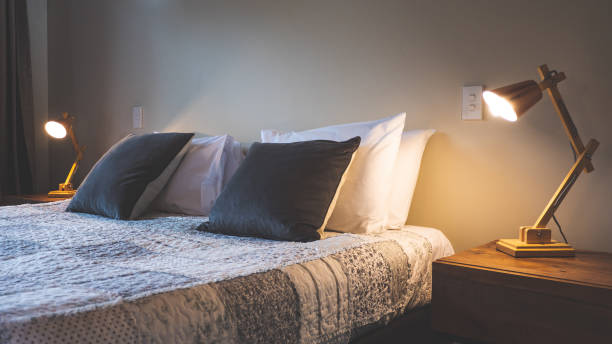 istock Bedroom hotel room interior bed double single luxury bedding folded towels simple tidy clean cushions pillows 2206429004
