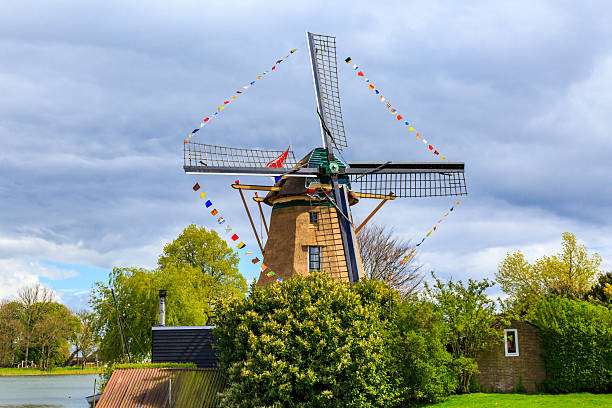 Europe,Netherlands, North Holland.  Weesp. Typical Molen, windmills with Dutch flags.  Molen Vriendscap, the Friendship windmills.