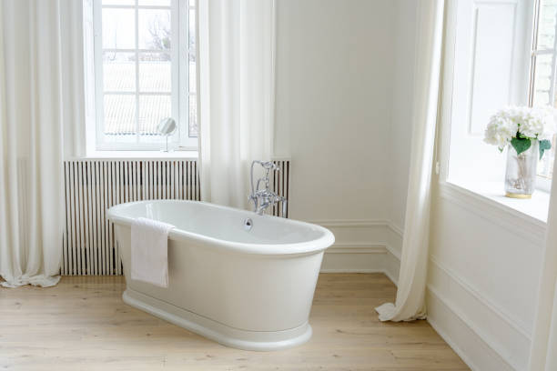 istock Bright and Elegant White Bathroom with Large Window 2206439122