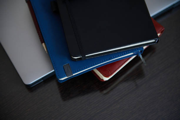 istock Organized Desk with Stacked Notebooks and Laptop for Productivity 2206439864