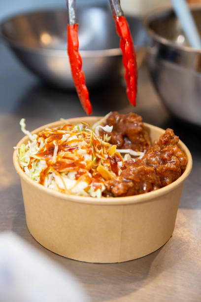 istock Korean deep-fried chicken on white rice with hot spicy sauce 2206447824