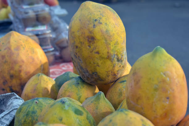 Closeup shot of fresh papayas on a blurred background