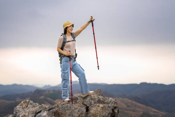 Middle-aged woman carrying a backpack trekking in the mountains