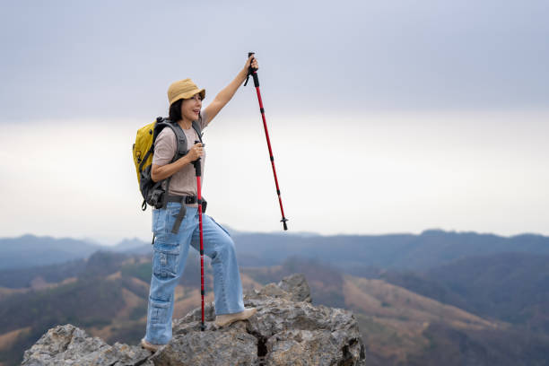 Middle-aged woman carrying a backpack trekking in the mountains