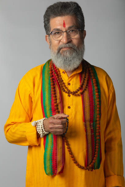 istock Old priest with rudraksha posing on white background 2206460811