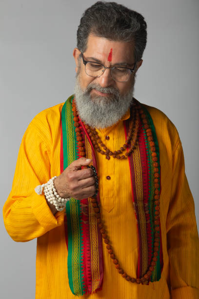 istock Old priest with rudraksha posing on white background 2206460815
