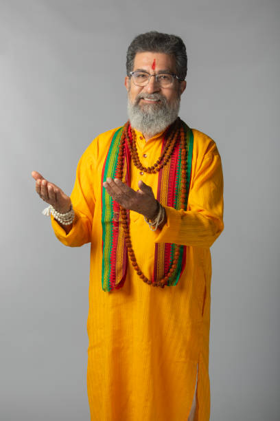 istock Old priest with rudraksha posing on white background 2206460911